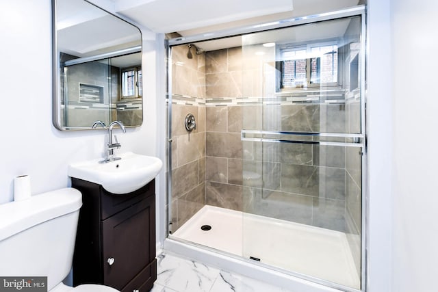 bathroom featuring walk in shower, vanity, and toilet