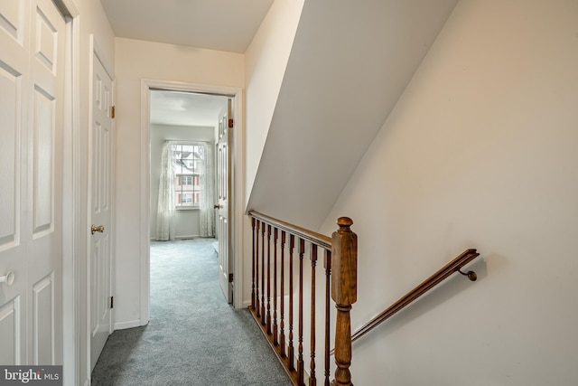 hall with light colored carpet