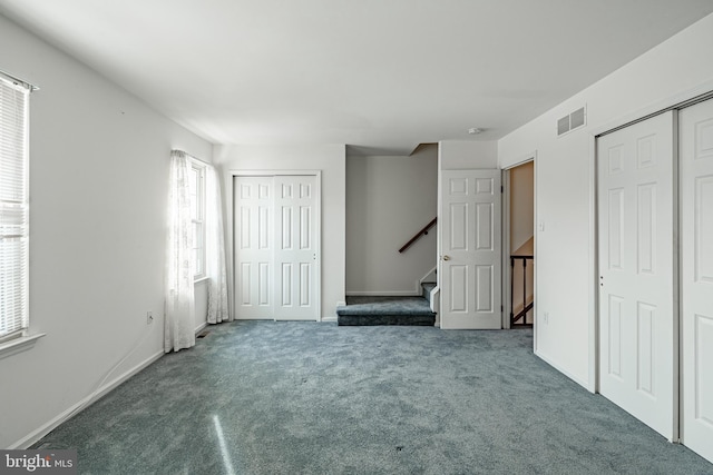 unfurnished bedroom featuring dark carpet