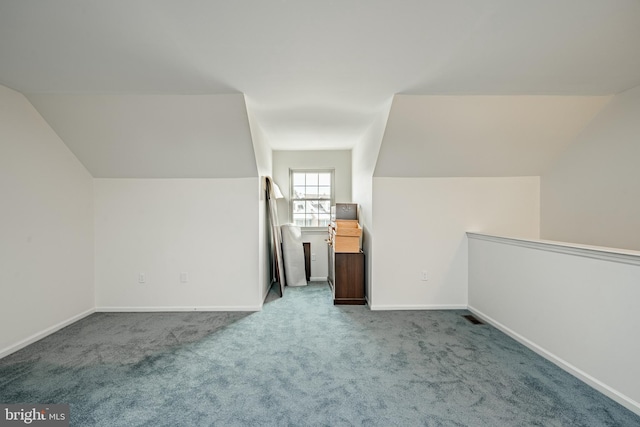 bonus room featuring vaulted ceiling and carpet flooring