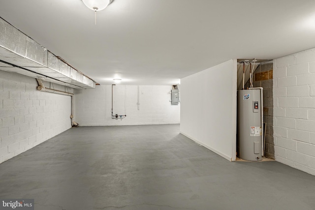 basement featuring electric panel and electric water heater