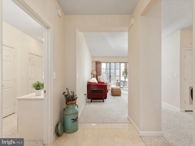 hallway with light colored carpet