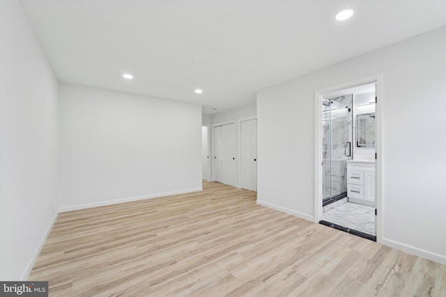 unfurnished room with light wood-type flooring