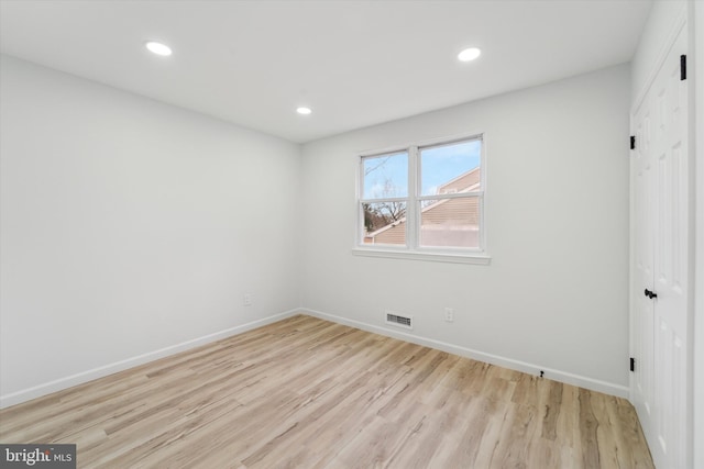 empty room with light hardwood / wood-style flooring