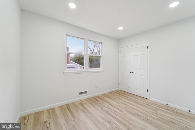 spare room with light hardwood / wood-style floors