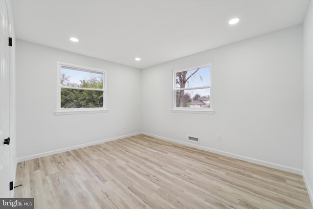 empty room featuring plenty of natural light and light wood-type flooring