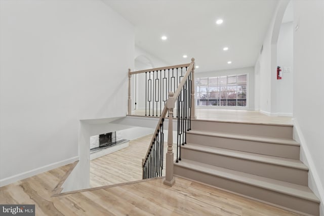 stairway with hardwood / wood-style flooring