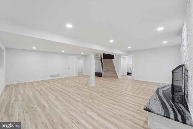 interior space with a fireplace and light wood-type flooring