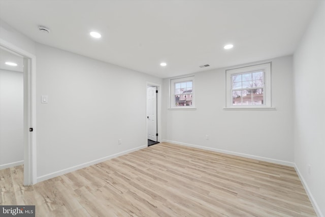 spare room featuring light hardwood / wood-style flooring