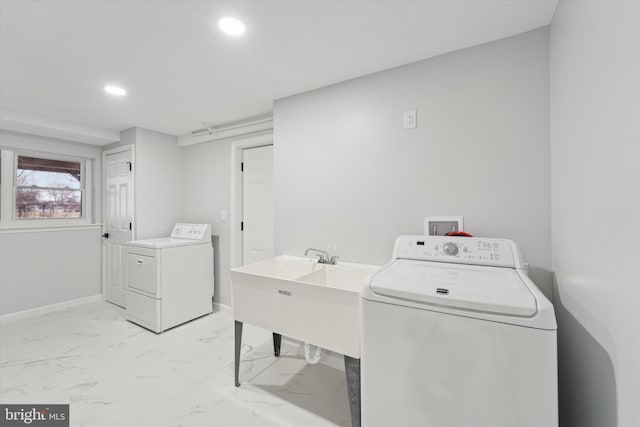 clothes washing area featuring separate washer and dryer and sink