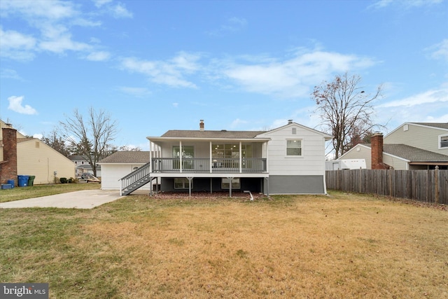 rear view of property featuring a porch and a yard