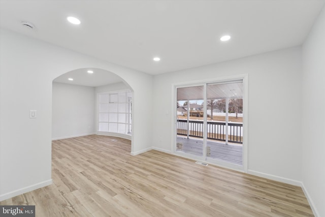 spare room with light hardwood / wood-style flooring