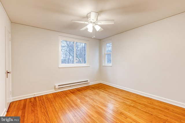 empty room with a baseboard radiator, ceiling fan, and light wood-type flooring