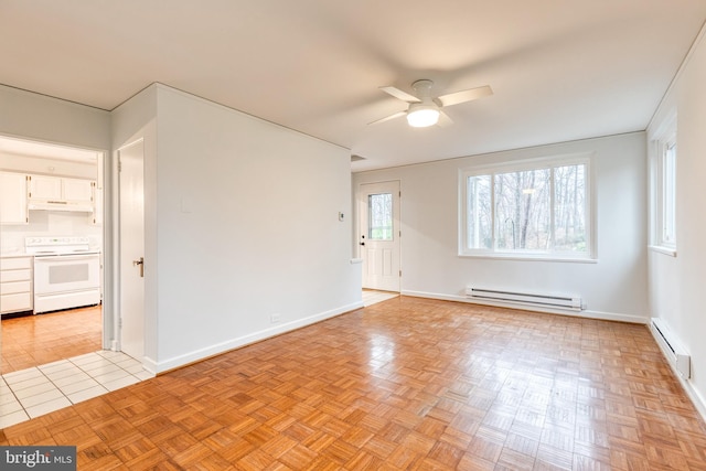 spare room featuring ceiling fan, light parquet flooring, and baseboard heating