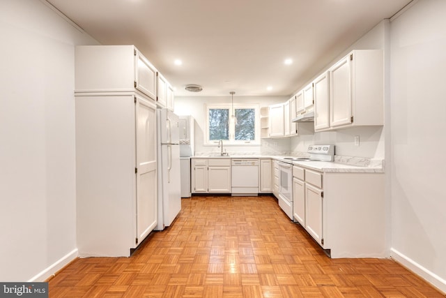 kitchen featuring white cabinetry, sink, pendant lighting, and white appliances