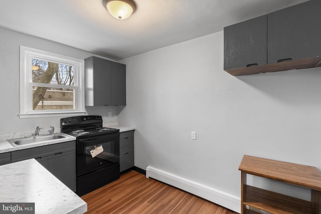 kitchen with baseboard heating, sink, black range with electric cooktop, and hardwood / wood-style flooring