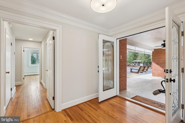 entryway with crown molding, a baseboard radiator, french doors, and light wood-type flooring