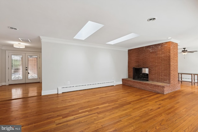 unfurnished living room with a brick fireplace, a baseboard radiator, ornamental molding, and wood-type flooring