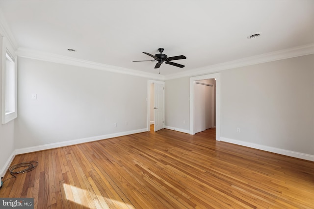 unfurnished bedroom with wood-type flooring, ornamental molding, ceiling fan, and a closet