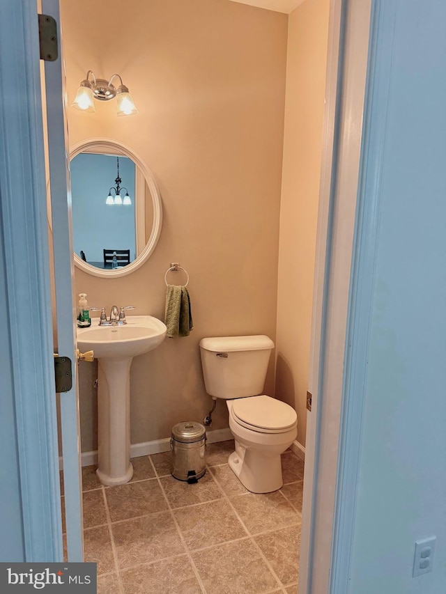 bathroom with tile patterned flooring, sink, and toilet