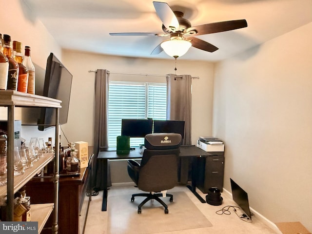 carpeted home office with ceiling fan