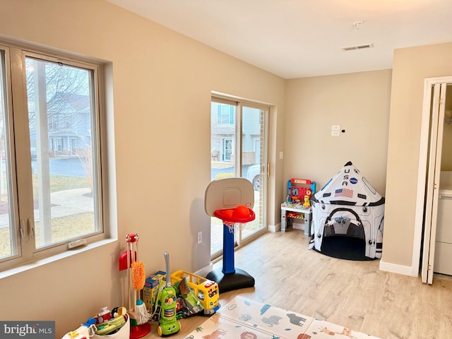 rec room with light hardwood / wood-style floors