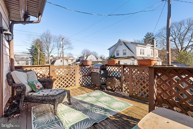 wooden terrace featuring area for grilling