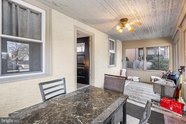 sunroom / solarium with wooden ceiling and ceiling fan