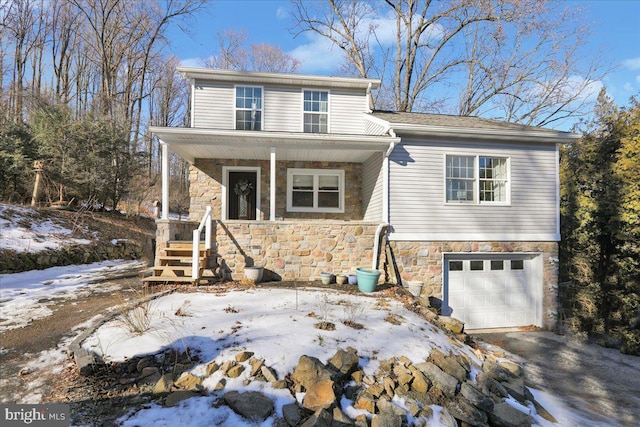 front facade with a garage and covered porch