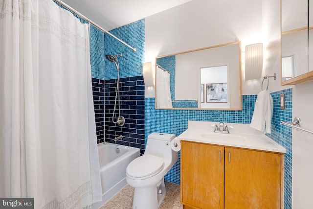 full bath with toilet, shower / bath combo with shower curtain, tile walls, and vanity