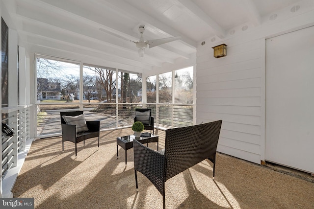 sunroom / solarium with ceiling fan and beam ceiling