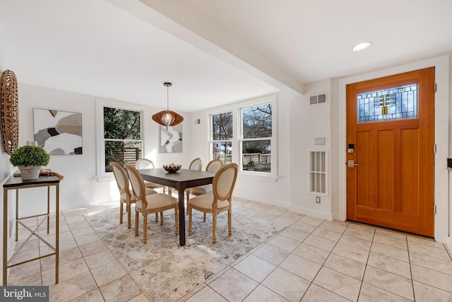 dining room with a healthy amount of sunlight, visible vents, and light tile patterned floors