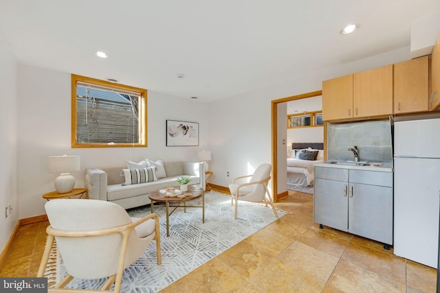 living room featuring recessed lighting and baseboards