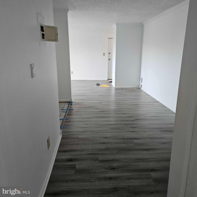 empty room with a textured ceiling and wood finished floors