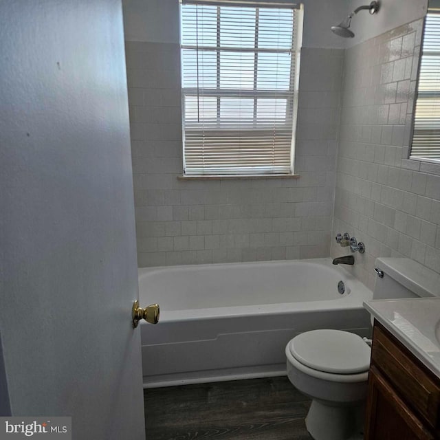 bathroom featuring toilet, bathtub / shower combination, wood finished floors, and vanity