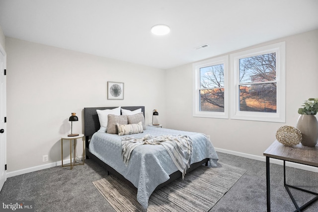 bedroom with dark colored carpet