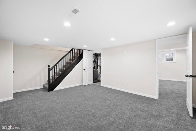 basement featuring dark colored carpet