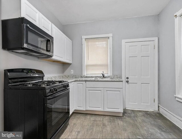 5224 Rodman St, Philadelphia, PA 19143 - kitchen with sink, white cabinets, and black appliances