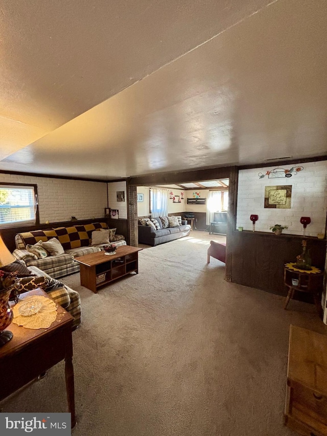 living room with brick wall and carpet floors