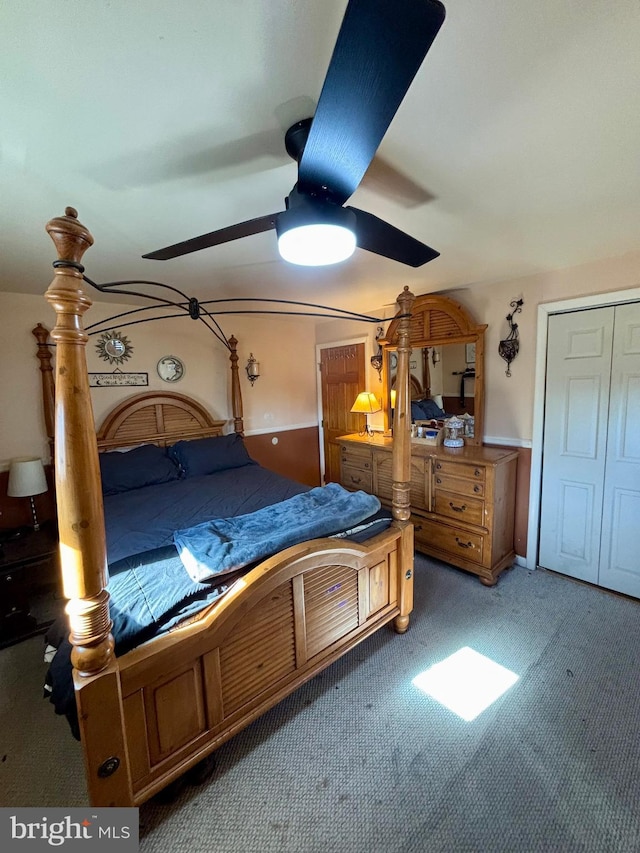 carpeted bedroom featuring a closet and ceiling fan