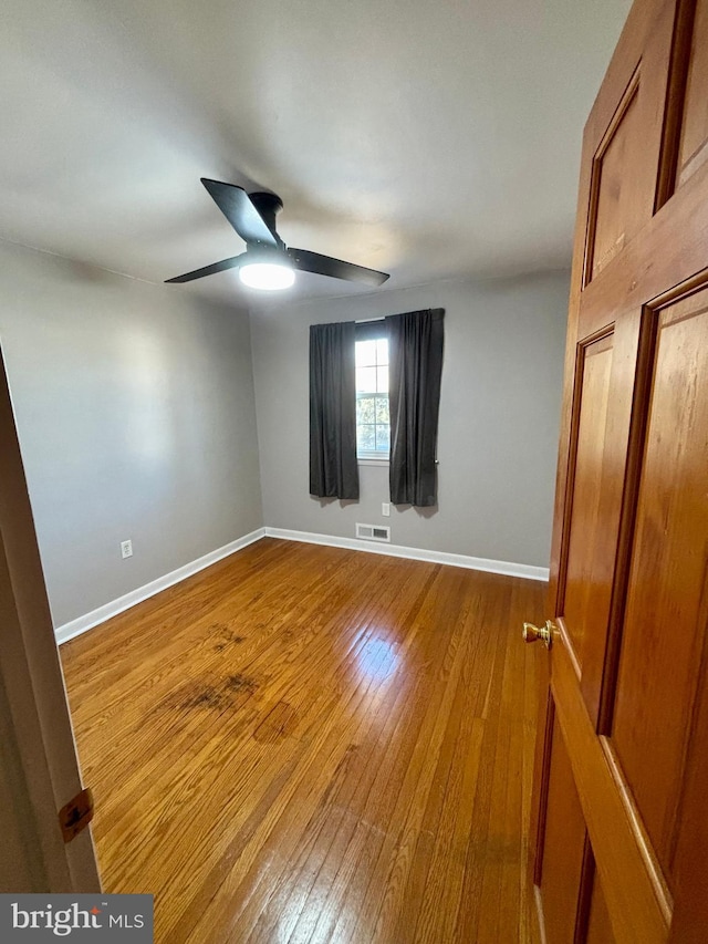 unfurnished room featuring hardwood / wood-style flooring and ceiling fan