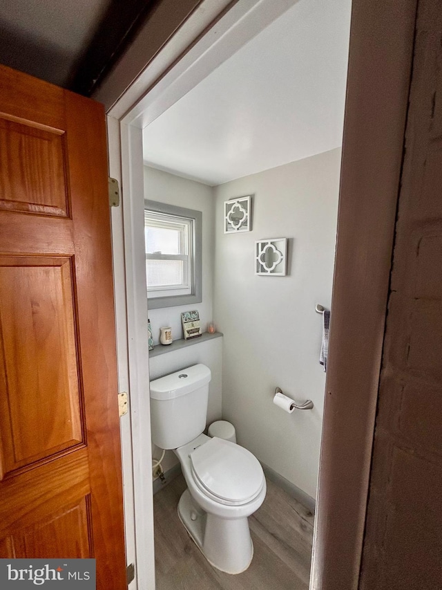 bathroom featuring hardwood / wood-style flooring and toilet