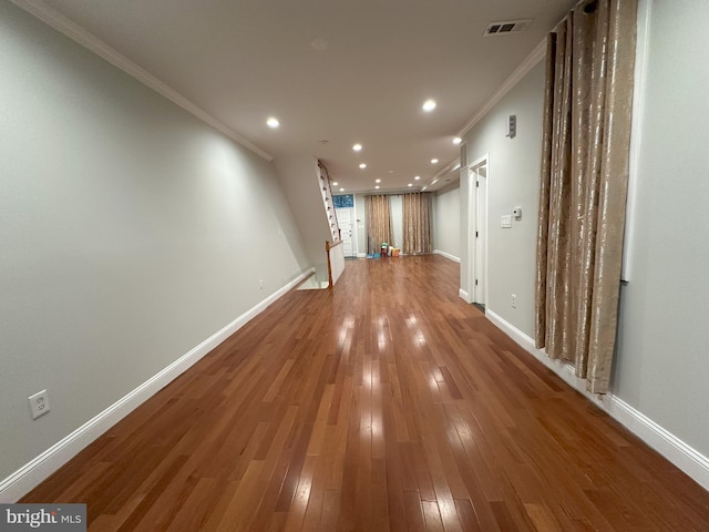 corridor with crown molding and hardwood / wood-style floors