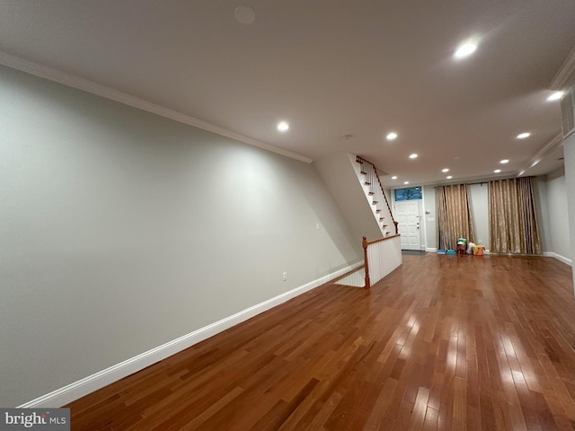 basement with crown molding and hardwood / wood-style flooring