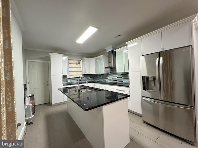 kitchen with stainless steel refrigerator with ice dispenser, a center island, sink, and white cabinets