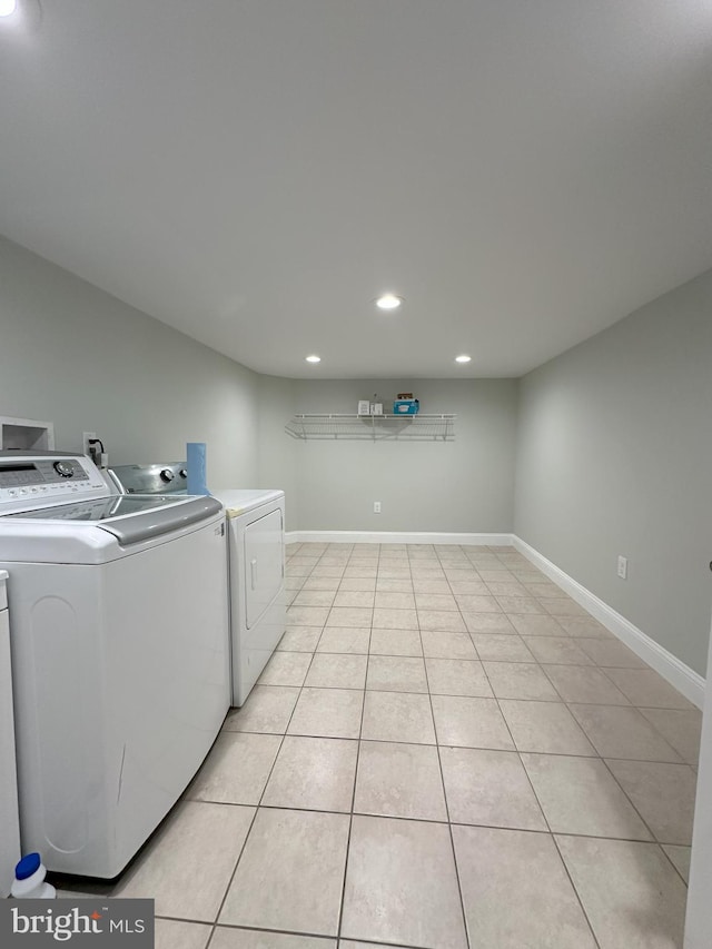 laundry room featuring light tile patterned floors and washing machine and clothes dryer