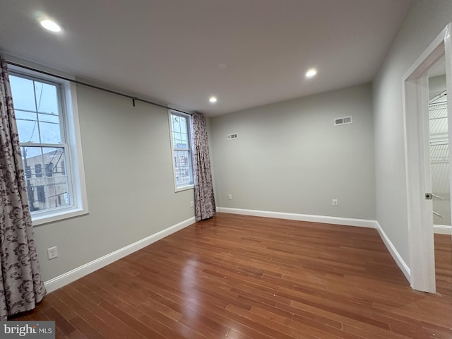 unfurnished room featuring hardwood / wood-style flooring