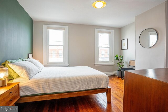 bedroom featuring multiple windows and light wood-type flooring