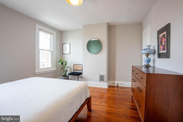 bedroom featuring dark hardwood / wood-style flooring