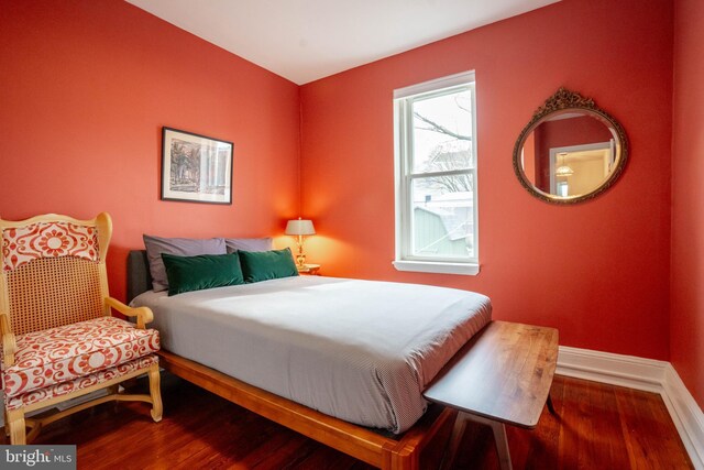 bedroom with hardwood / wood-style floors